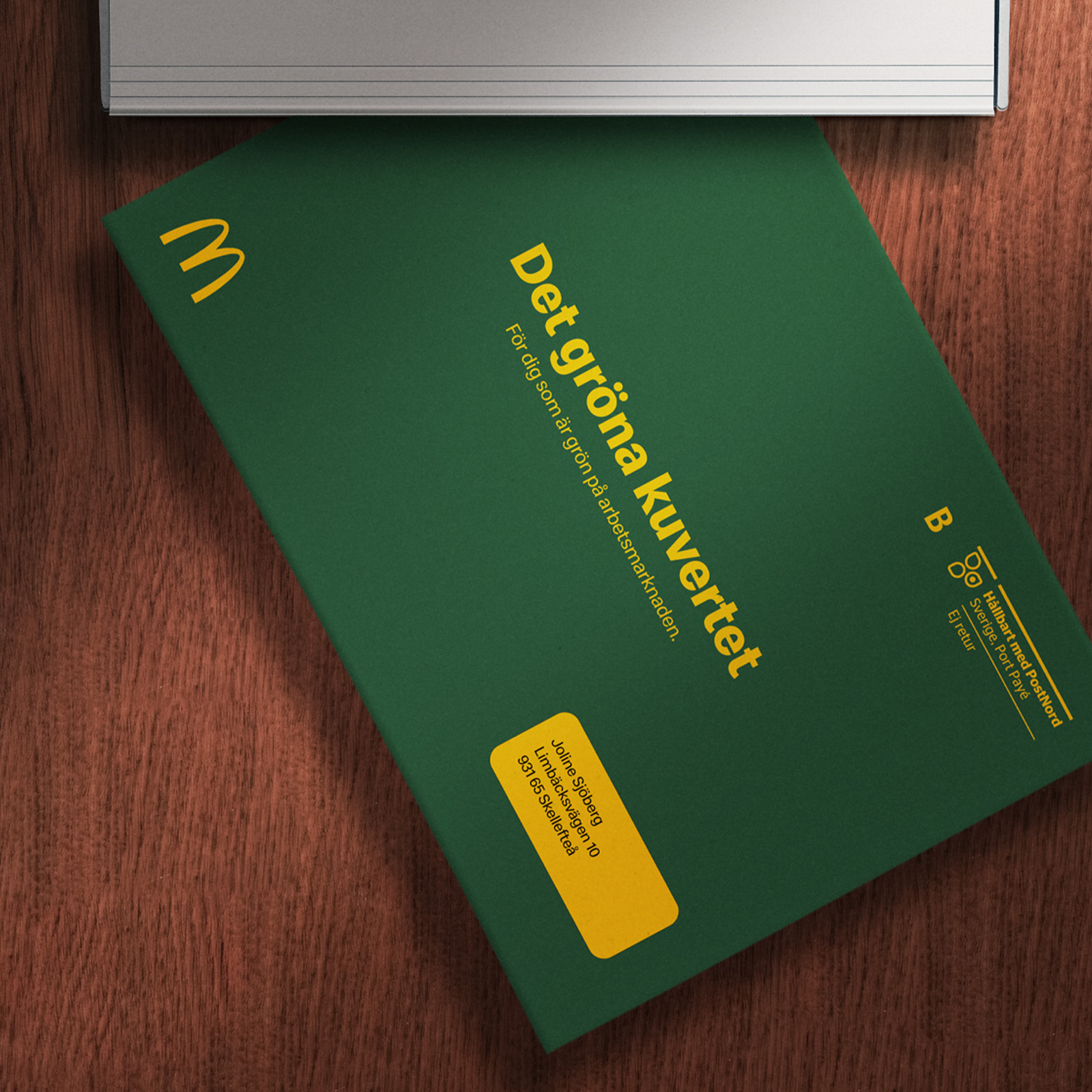 Green McDonald's envelope in a letterbox