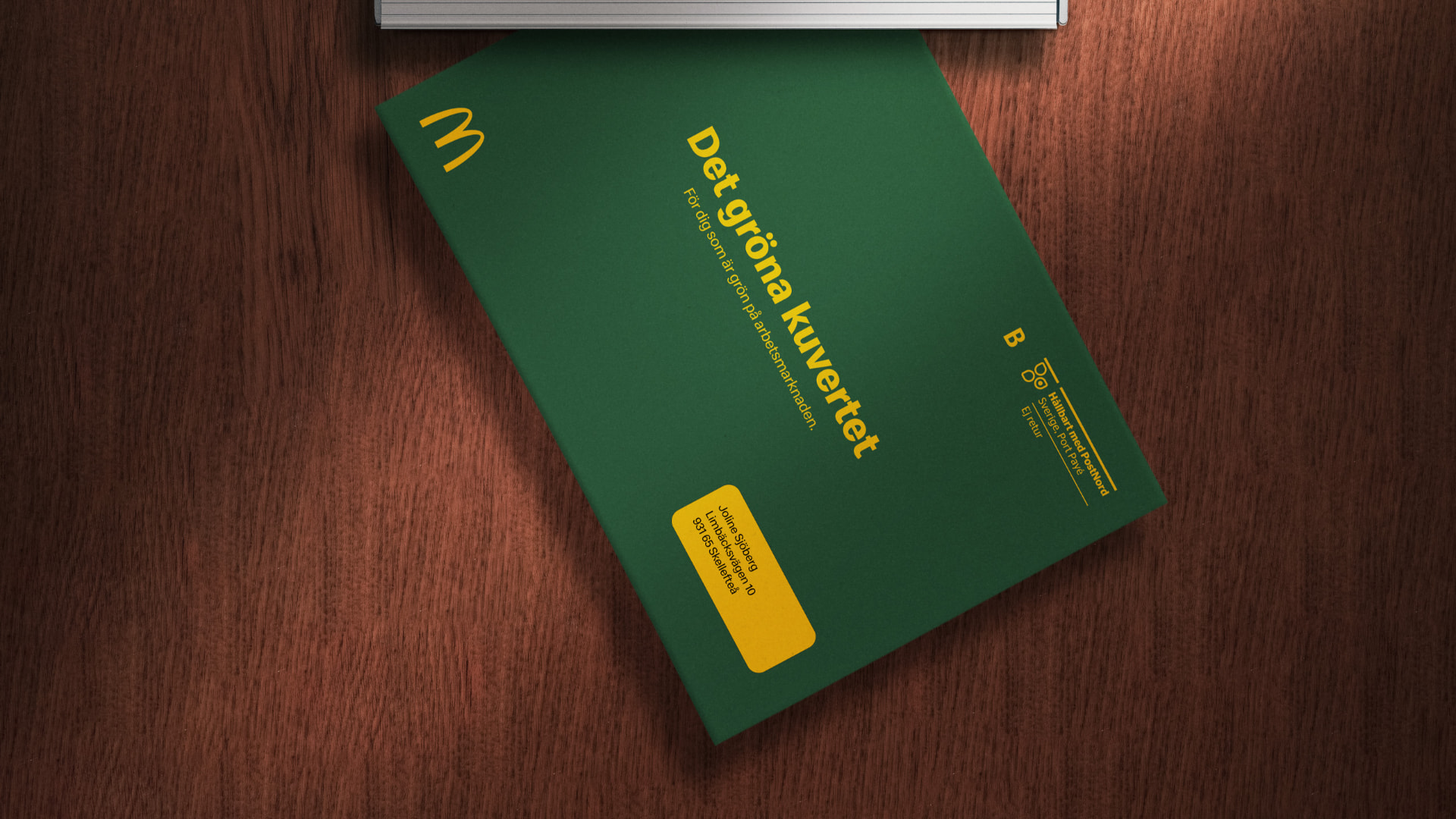 Green McDonald's envelope in a letterbox