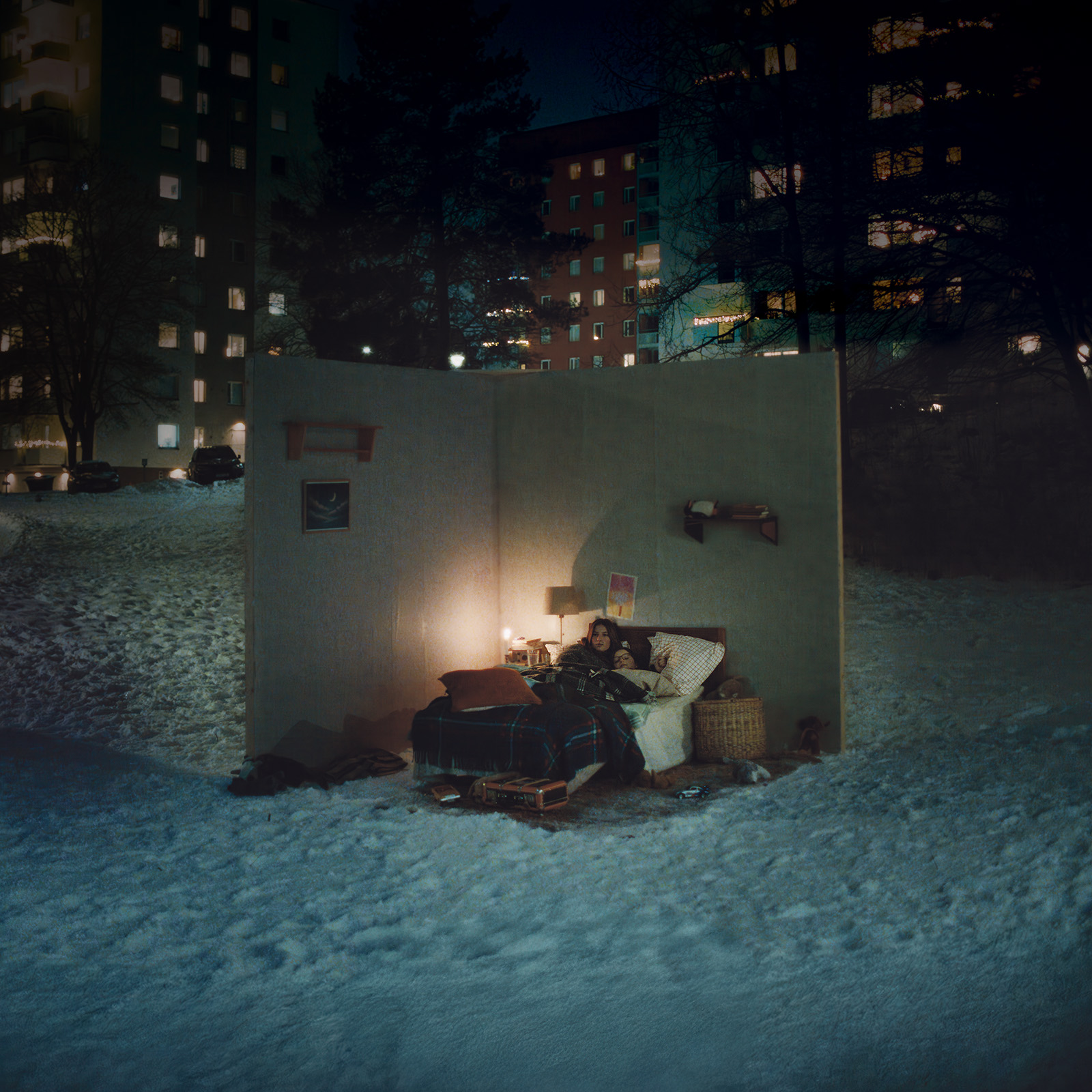 Bedroom recreated outdoors in the snow at night