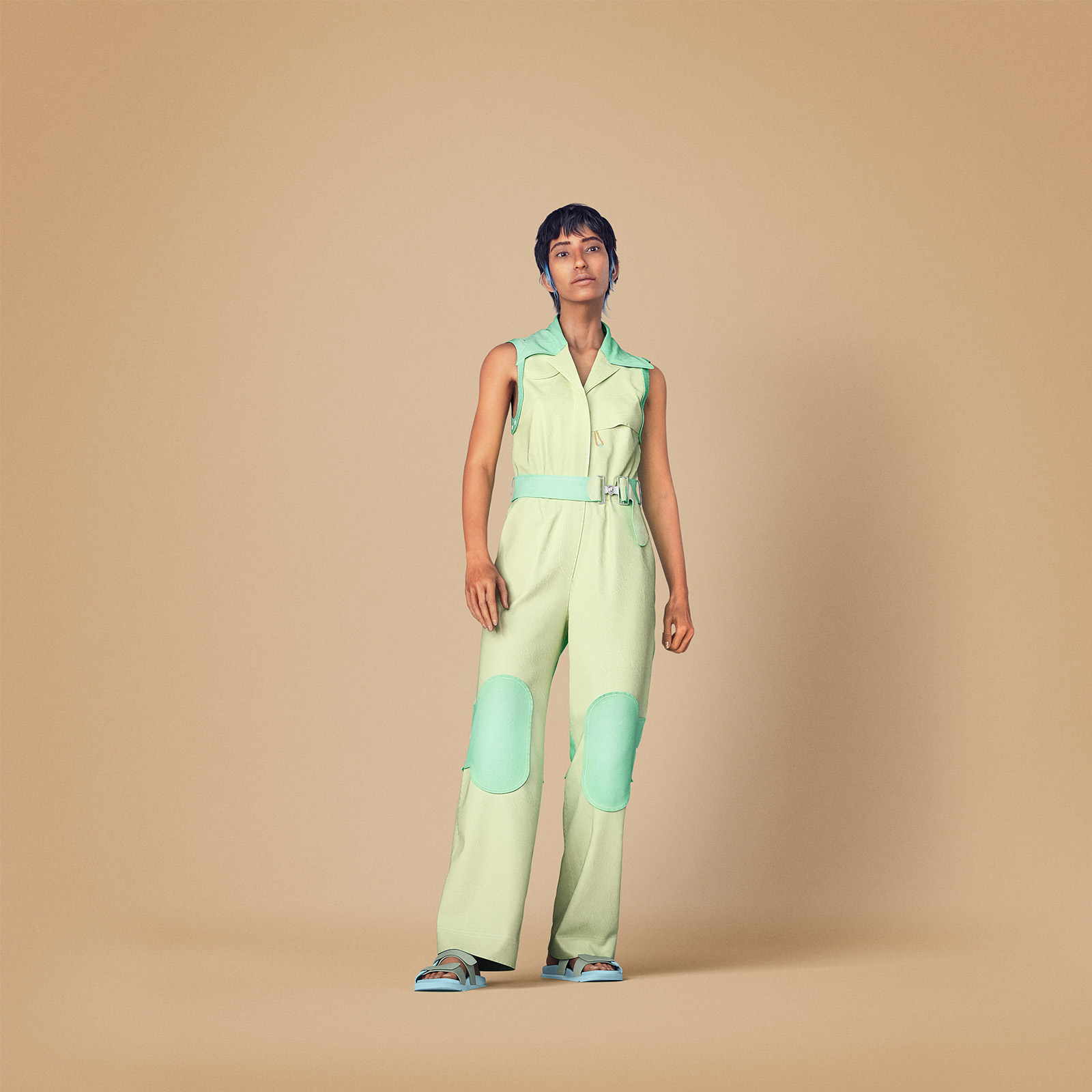 Model in a light green belted jumpsuit from the Billion Dollar Collection