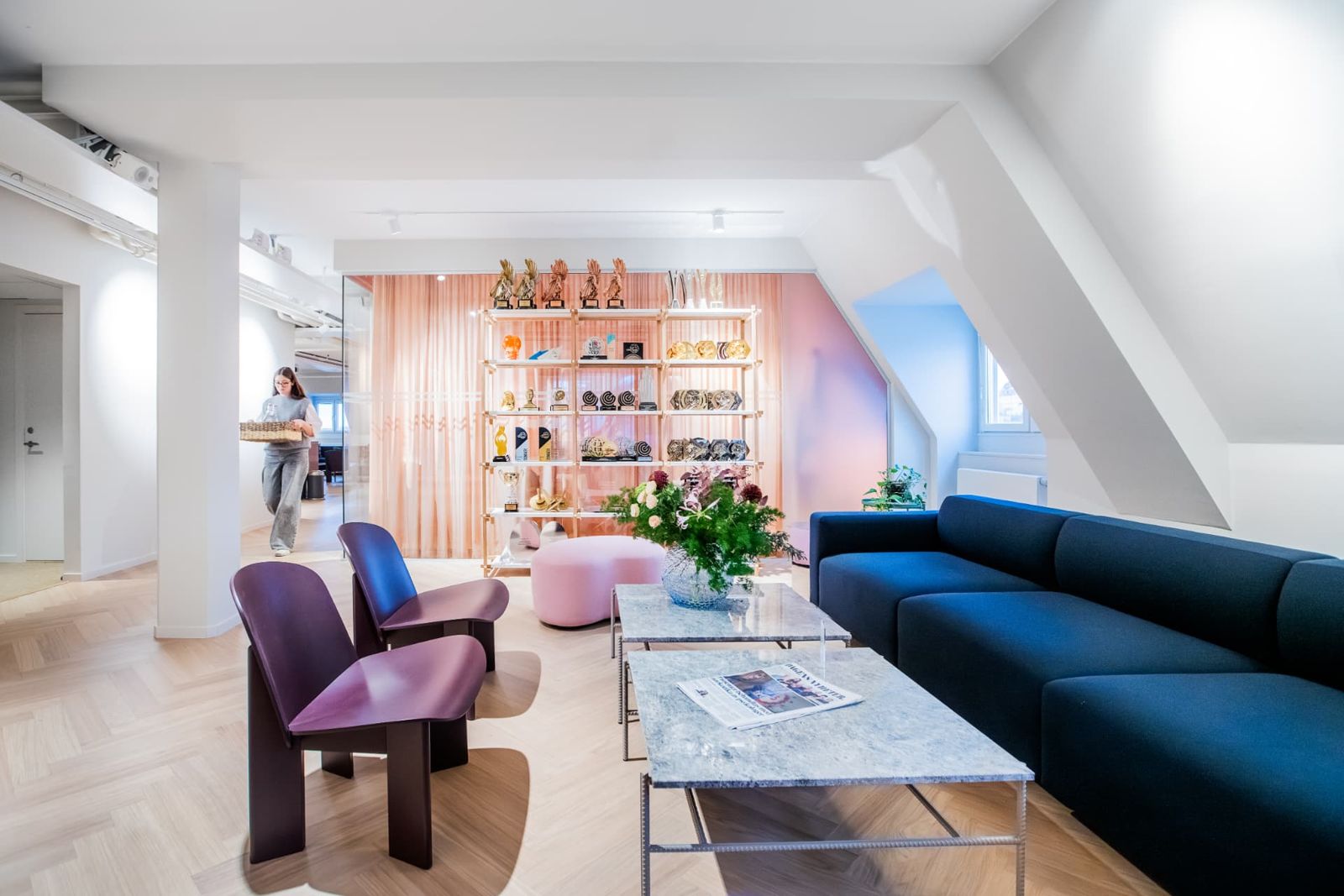 The Prime office lounge with blue sofa and award shelf