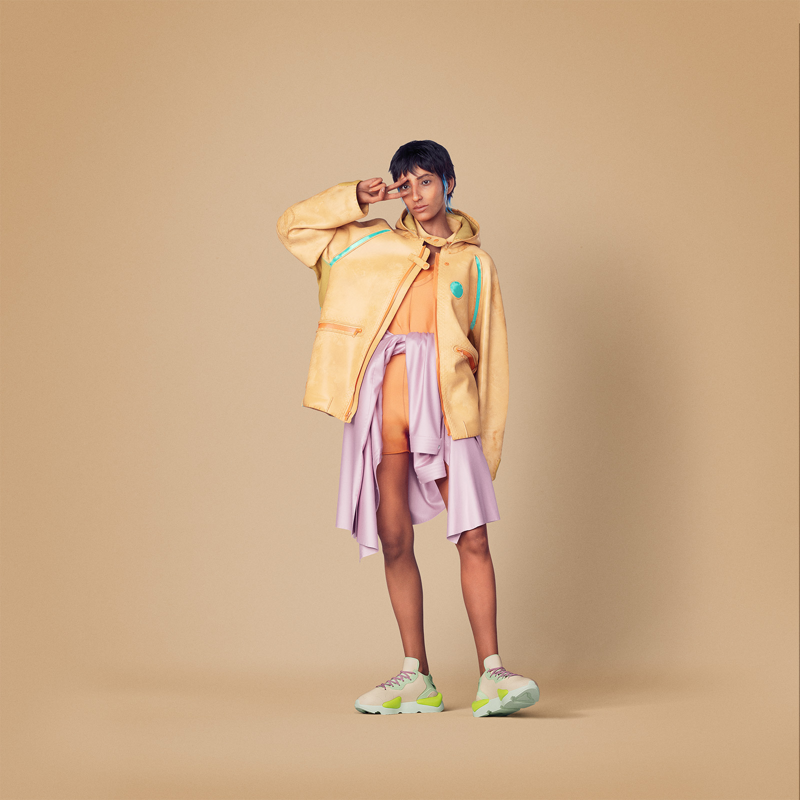 Model in a yellow jacket and pink layers from the Billion Dollar Collection